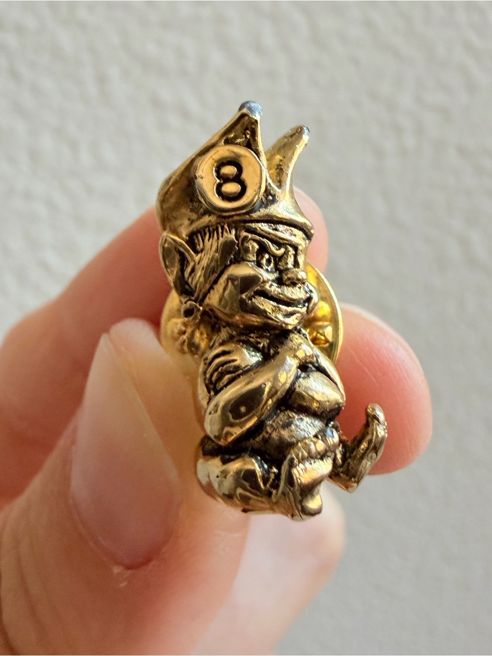 Vintage gremlin leprechaun lapel pin with a hat and the number 8